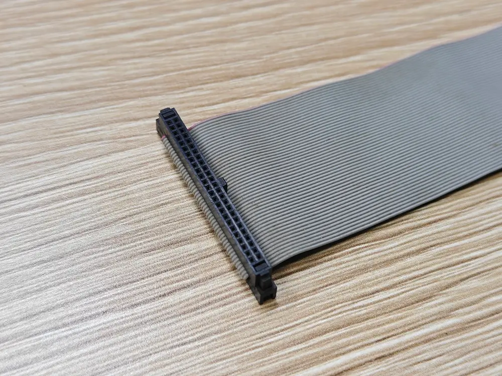 Black ribbon connector with its contact openings and cable entry visible